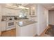 Bright kitchen with white cabinets and granite countertops at 3251 White Ibis Ct # C4, Punta Gorda, FL 33950