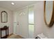 Bright entryway with white door, wood floors, and decorative mirrors at 3251 White Ibis Ct # C4, Punta Gorda, FL 33950