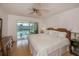 King-size bed, wood dresser, and access to the balcony at 3251 White Ibis Ct # C4, Punta Gorda, FL 33950