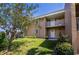 Tan condo building with white balcony and landscaping at 3251 White Ibis Ct # C4, Punta Gorda, FL 33950
