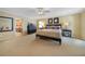 Bright bedroom with king-size bed and ensuite bathroom access at 28 Colony Point Dr, Punta Gorda, FL 33950