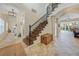 Bright and airy entryway with tiled floors and a view of the living room and staircase at 28 Colony Point Dr, Punta Gorda, FL 33950