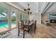 Bright dining room with pool view and wooden table at 28 Colony Point Dr, Punta Gorda, FL 33950