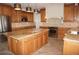 Island kitchen with granite countertops and wood cabinetry at 28 Colony Point Dr, Punta Gorda, FL 33950