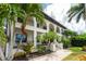 Two-story home with double doors and palm trees at 28 Colony Point Dr, Punta Gorda, FL 33950