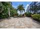 Expansive patio with fire pit and lush tropical landscaping at 28 Colony Point Dr, Punta Gorda, FL 33950