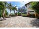 Expansive patio with fire pit and lush tropical landscaping at 28 Colony Point Dr, Punta Gorda, FL 33950