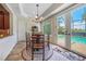Cozy breakfast nook with pool view and round table at 28 Colony Point Dr, Punta Gorda, FL 33950