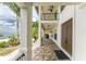 Covered porch with double doors and tile flooring at 28 Colony Point Dr, Punta Gorda, FL 33950