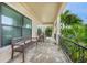 Relaxing front porch with rocking chairs and view of lush landscaping at 28 Colony Point Dr, Punta Gorda, FL 33950