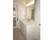 Bathroom with single vanity, marble countertop, and access to the backyard at 28 Colony Point Dr, Punta Gorda, FL 33950