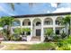 Two-story home with double doors and palm trees at 28 Colony Point Dr, Punta Gorda, FL 33950