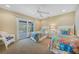 Bedroom with twin beds and sliding glass doors to balcony at 28 Colony Point Dr, Punta Gorda, FL 33950