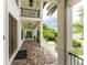 Covered porch with tile floor and wrought iron railings, showcasing a waterfront view at 28 Colony Point Dr, Punta Gorda, FL 33950