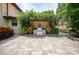 Built-in outdoor kitchen with pergola and lush landscaping at 28 Colony Point Dr, Punta Gorda, FL 33950