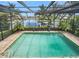 Inviting, screened-in pool area with serene canal views at 28 Colony Point Dr, Punta Gorda, FL 33950