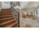 Elegant staircase with wrought iron railing leading to a spacious living area at 28 Colony Point Dr, Punta Gorda, FL 33950