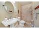 Clean bathroom with shower, pedestal sink, and tile flooring at 28 Colony Point Dr, Punta Gorda, FL 33950