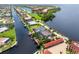 Aerial view of a luxury waterfront home with pool and canal access at 28 Colony Point Dr, Punta Gorda, FL 33950
