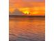 Orange and yellow sunset reflecting on calm water at 28 Colony Point Dr, Punta Gorda, FL 33950