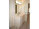 Bathroom with single vanity, marble countertop and LED lighting at 28 Colony Point Dr, Punta Gorda, FL 33950