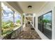 Covered porch with tile flooring, offering water views and access to the home at 28 Colony Point Dr, Punta Gorda, FL 33950
