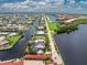 Aerial view showing a waterfront home with a private pool and dock at 28 Colony Point Dr, Punta Gorda, FL 33950