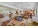 Open living room with large windows, comfortable seating, and views of the kitchen at 28 Colony Point Dr, Punta Gorda, FL 33950