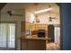 Open kitchen with vaulted ceiling, breakfast bar, and access to a patio at 1565 Dorchester St, Port Charlotte, FL 33952