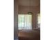 Simple dining room with carpet flooring and access to a patio or deck at 1565 Dorchester St, Port Charlotte, FL 33952
