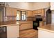 Galley-style kitchen with light-colored cabinets and wood flooring at 1565 Dorchester St, Port Charlotte, FL 33952