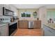 Stylish kitchen featuring modern appliances, a granite countertop, and ample cabinet storage at 3512 Nekoosa St, North Port, FL 34287