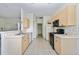 View of kitchen with appliances and light wood cabinets at 2503 Dumont Ln, North Port, FL 34286