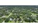 Aerial view of a residential neighborhood showcasing various houses nestled amongst lush greenery at 182 Monica St, Port Charlotte, FL 33954