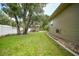 Landscaped side yard with shed and mature trees at 182 Monica St, Port Charlotte, FL 33954
