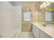Bright bathroom with white tile, bathtub, and vanity at 182 Monica St, Port Charlotte, FL 33954
