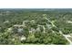 Aerial perspective showcasing a neighborhood surrounded by dense greenery and various homes at 182 Monica St, Port Charlotte, FL 33954