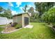 Well-maintained storage shed with a bench in a landscaped area at 182 Monica St, Port Charlotte, FL 33954