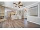 Bright Gathering room with wood-look floors, high ceilings, and views to kitchen and entry at 182 Monica St, Port Charlotte, FL 33954