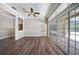 Gathering room with wood-look floors, and sliding glass doors to the pool at 182 Monica St, Port Charlotte, FL 33954