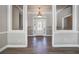 Elegant entryway with chandelier, stained glass door, and wood-look floors at 182 Monica St, Port Charlotte, FL 33954