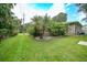 Landscaped backyard with lush tropical plants and a retaining wall at 182 Monica St, Port Charlotte, FL 33954