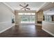 Spacious Gathering room features wood-look floors, fireplace, and sliding doors to the pool at 182 Monica St, Port Charlotte, FL 33954