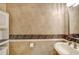 Powder room with pedestal sink and decorative wallpaper at 182 Monica St, Port Charlotte, FL 33954