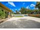 Large backyard with a long driveway and a white fence at 182 Monica St, Port Charlotte, FL 33954