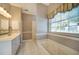 Primary bathroom with soaking tub, walk-in shower, and double vanity at 182 Monica St, Port Charlotte, FL 33954