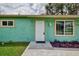 Newly painted teal home with white front door at 6701 Elmwood Rd, North Port, FL 34287