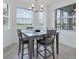 Bright dining area with gray table and chairs, looking out to a golf course view at 14071 Heritage Landing Blvd # 316, Punta Gorda, FL 33955