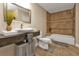 Clean bathroom with a bathtub, toilet, and floating vanity at 15300 Water Oak Ct, Punta Gorda, FL 33982