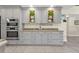 Modern kitchen with gray cabinets, granite counters, and double ovens at 15300 Water Oak Ct, Punta Gorda, FL 33982